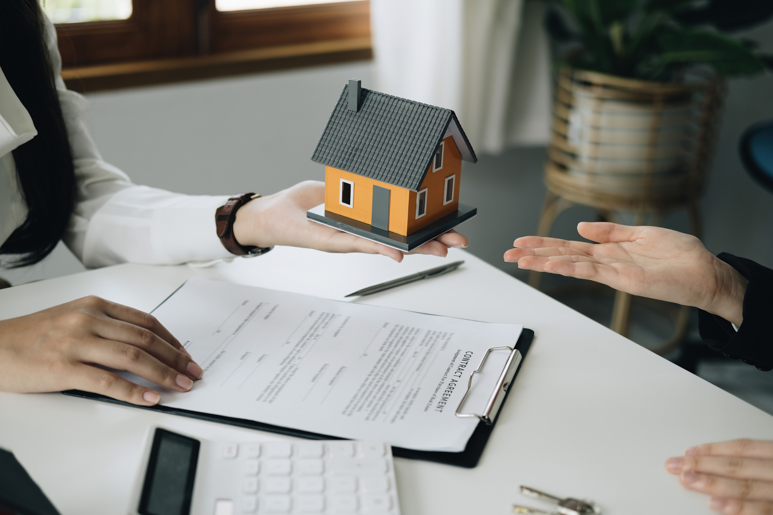 Guarantee, mortgage, agreement, contract, sign, real estate agent delivers the house to the customer after signing important contract documents Guarantee, mortgage, agreement, contract, sign, real estate agent delivers the house to the customer after signing important contract documents