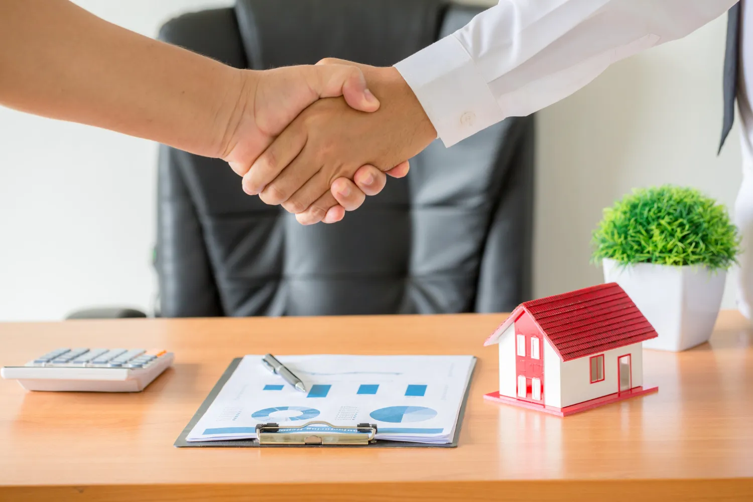 Hands of agent and client shaking hands after signed contract buy new apartment Hands of agent and client shaking hands after signed contract buy new apartment